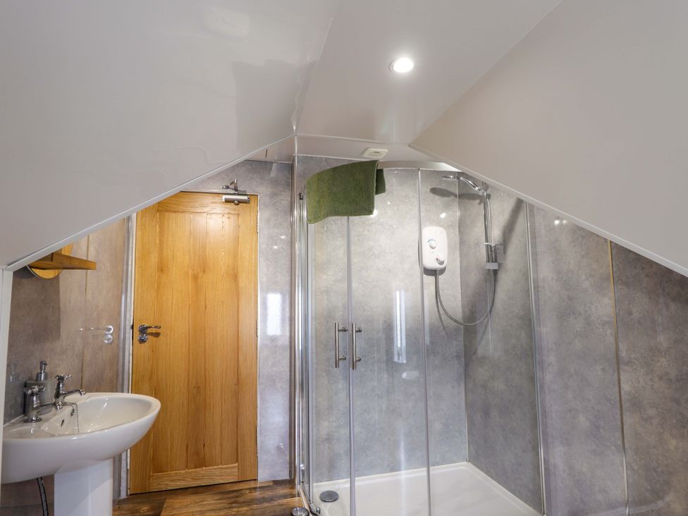 A bathroom with a shower and sink at Crannoch Self Catering in Cullen