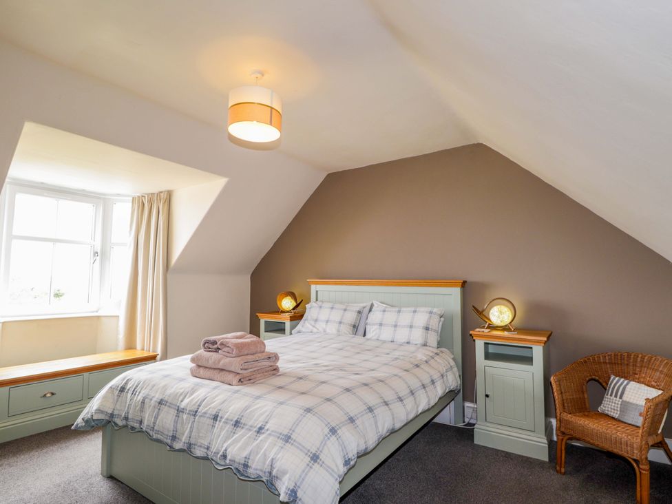 A bedroom with a bed and window at Crannoch Self Catering Cullen