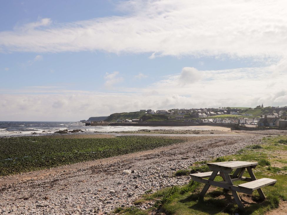 A beach with a picnic table and view of the sea at Crannoch Self Catering in Cullen