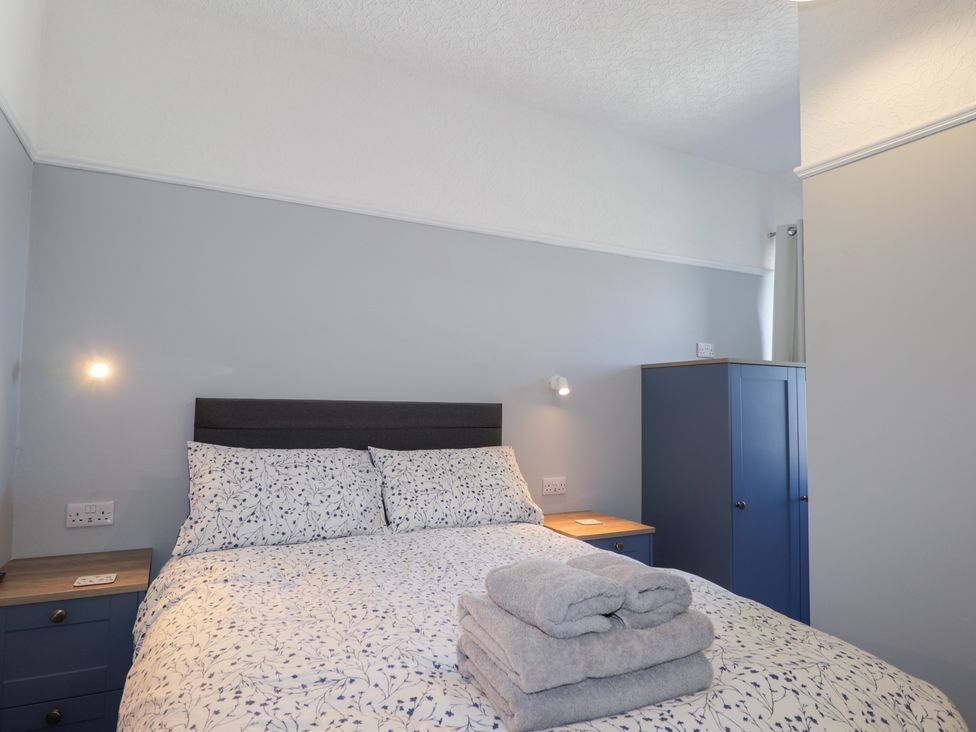 A bedroom with a bed and wardrobe at Crannoch Self Catering in Cullen