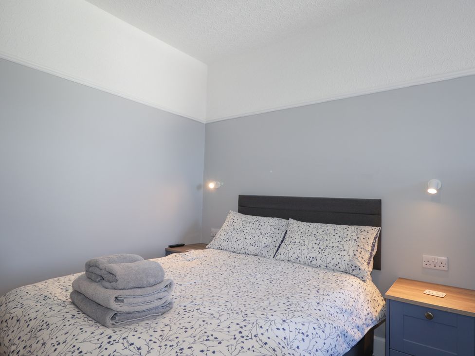 A bedroom with a bed and bedside table at Crannoch Self Catering in Cullen