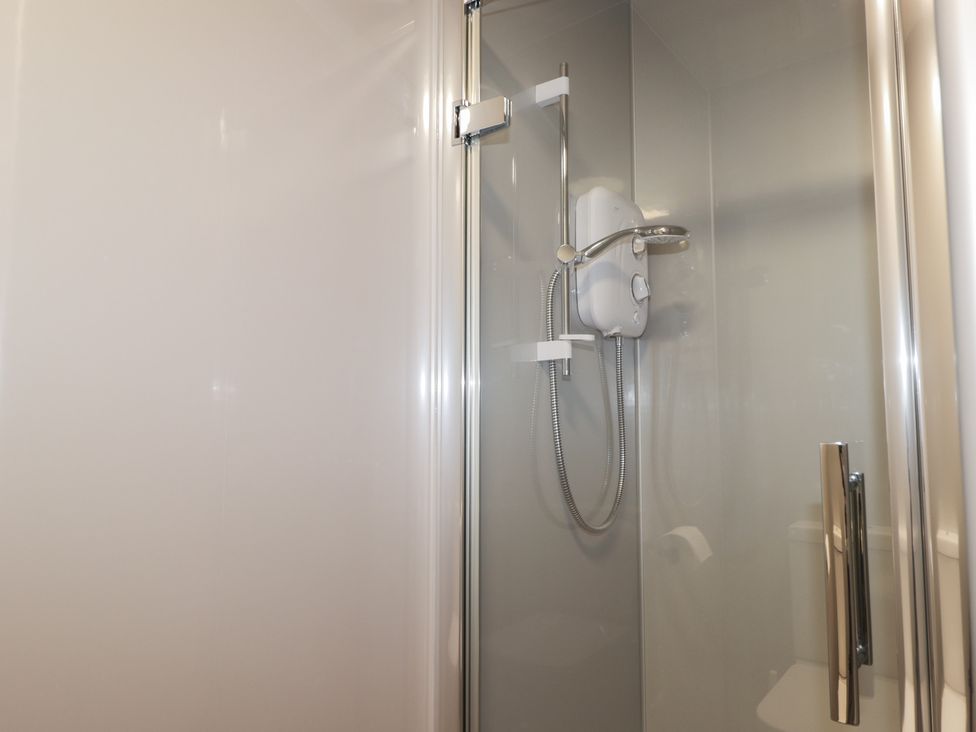 A shower with a showerhead and valve at Crannoch Self Catering in Cullen