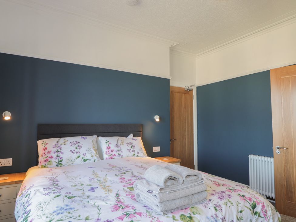 A bedroom with a bed and bedside table at Crannoch Self Catering in Cullen