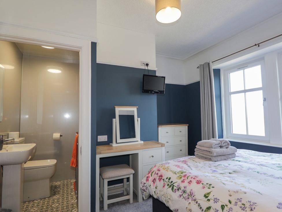 A bedroom with a bed and television at Crannoch Self Catering in Cullen