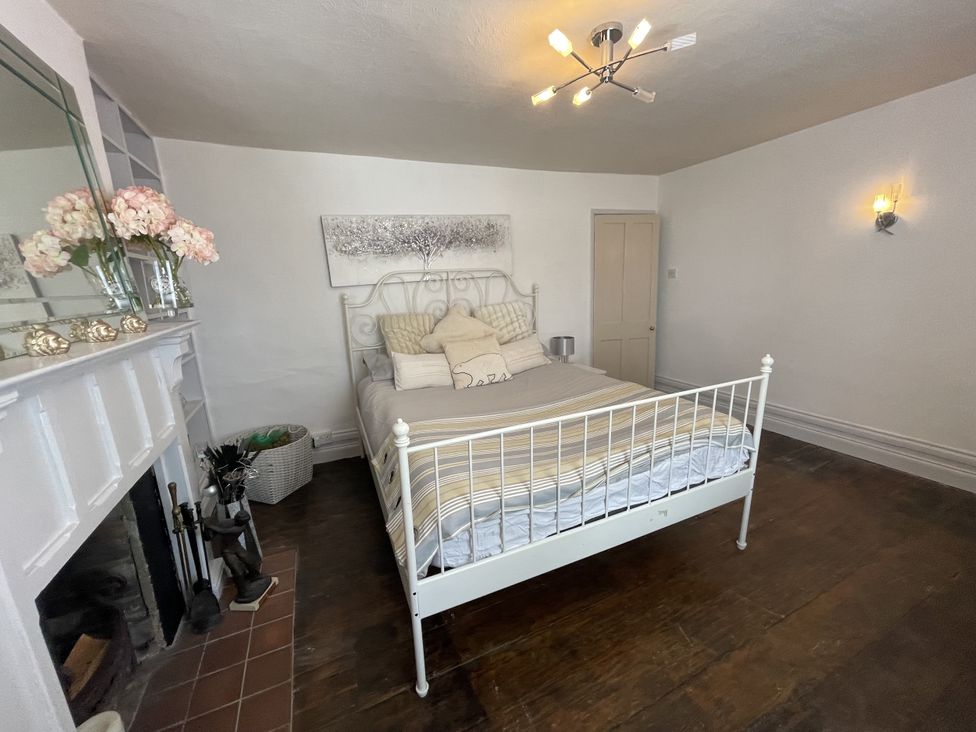 A bedroom with a bed and fireplace at 51 North Street, Wareham
