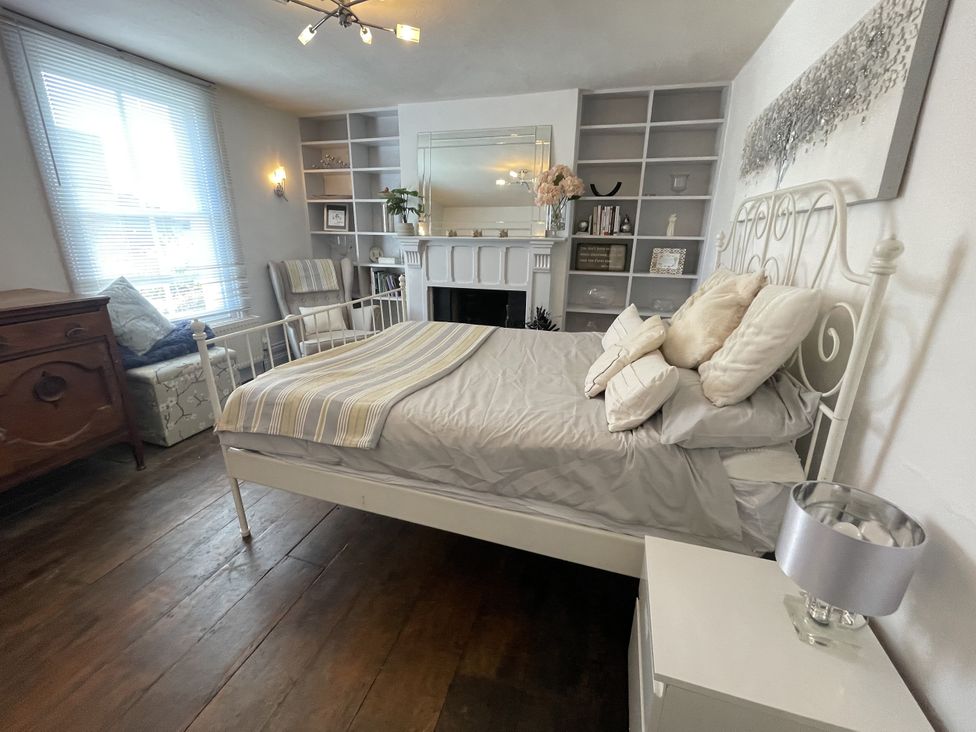 A bedroom with a bed and bookshelf at 51 North Street in Wareham