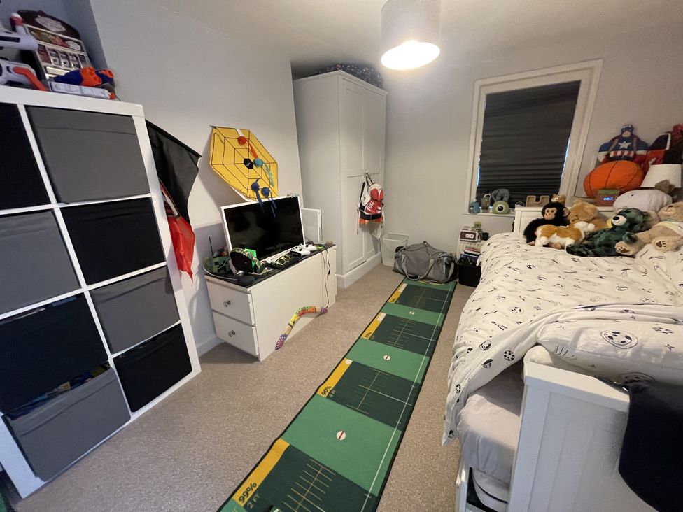 A bedroom with a bed and toys at 51 North Street Wareham