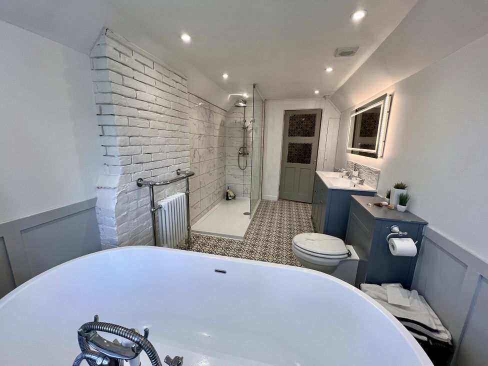 A bathroom with a bathtub, shower, and sink at 51 North Street in Wareham