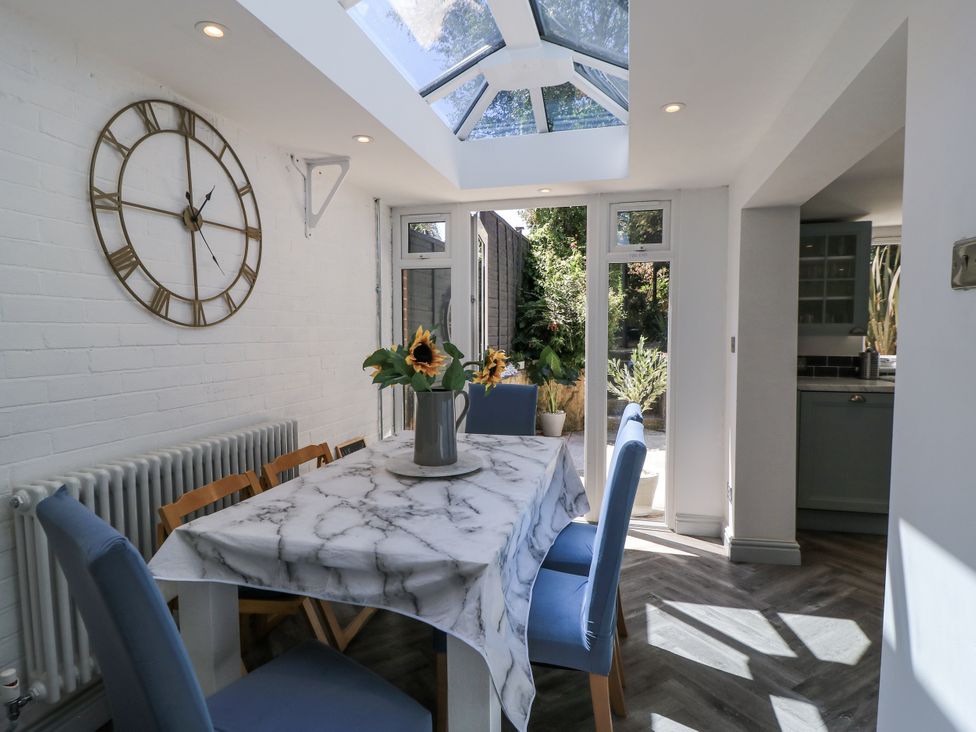 A dining room with a table and chairs at Delightful Dorset House By Wareham River Wareham