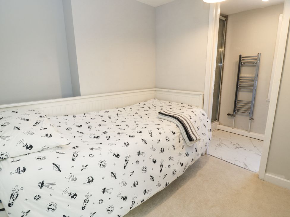 A bedroom with a bed and bathroom access at Delightful Dorset House By Wareham River, Wareham
