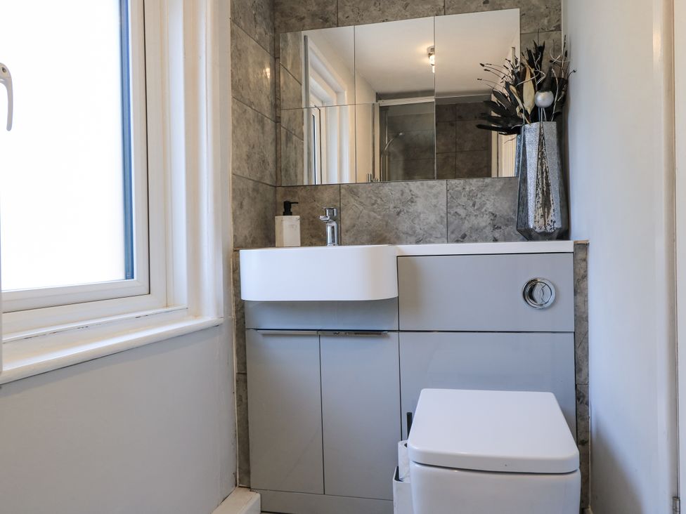 A bathroom with a sink and toilet at Delightful Dorset House By Wareham River, Wareham