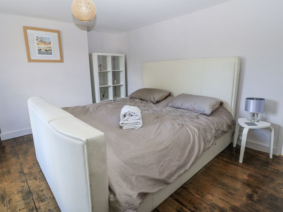 A bedroom with a bed and shelf at Delightful Dorset House By Wareham River in Wareham