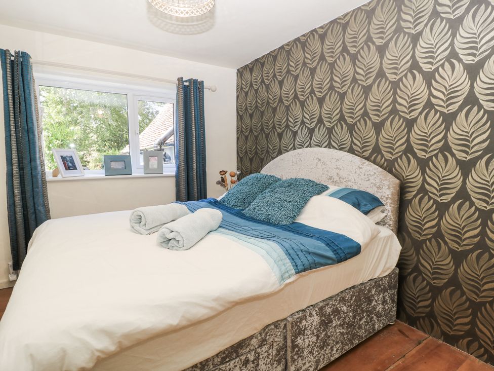 A bedroom with a bed and window at Delightful Dorset House By Wareham River in Wareham