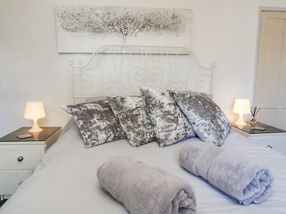 A bedroom with a bed and bedside tables at Delightful Dorset House By Wareham River in Wareham