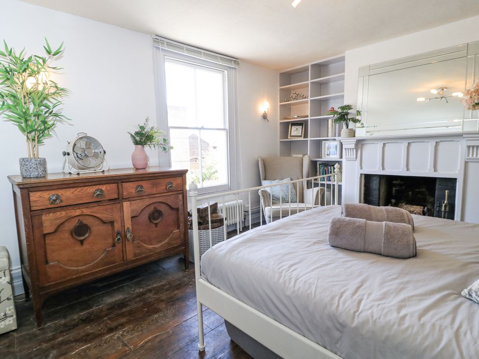A bedroom with a bed and dresser at Delightful Dorset House By Wareham River Wareham