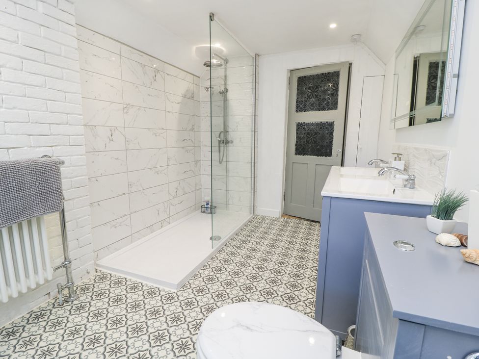 A bathroom with a shower and sink at Delightful Dorset House By Wareham River in Wareham