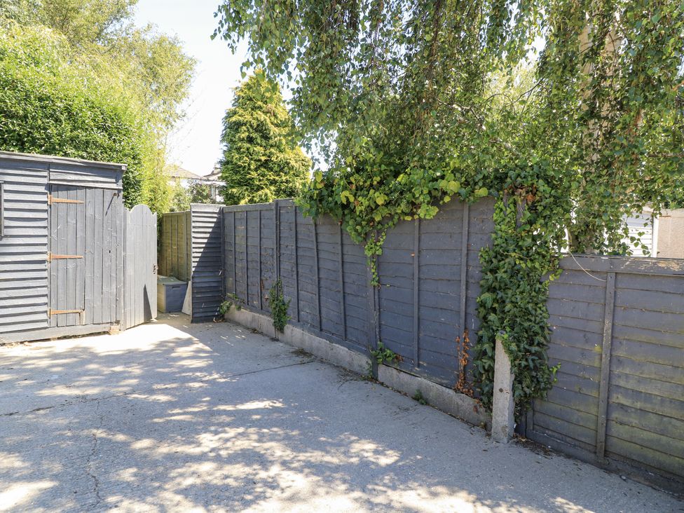 An outdoor area with a fence and shed at Delightful Dorset House By Wareham River Wareham