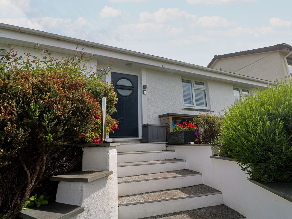 An outdoor entryway with steps and flower beds at 4 Cardell Way in Newquay