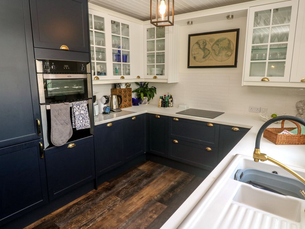 A kitchen with cabinets and appliances at 4 Cardell Way in Newquay