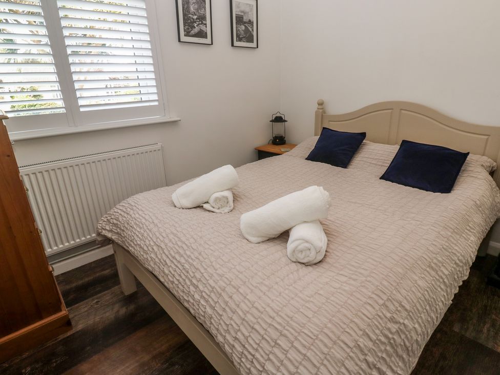 A bedroom with a bed and towels on it at 4 Cardell Way in Newquay
