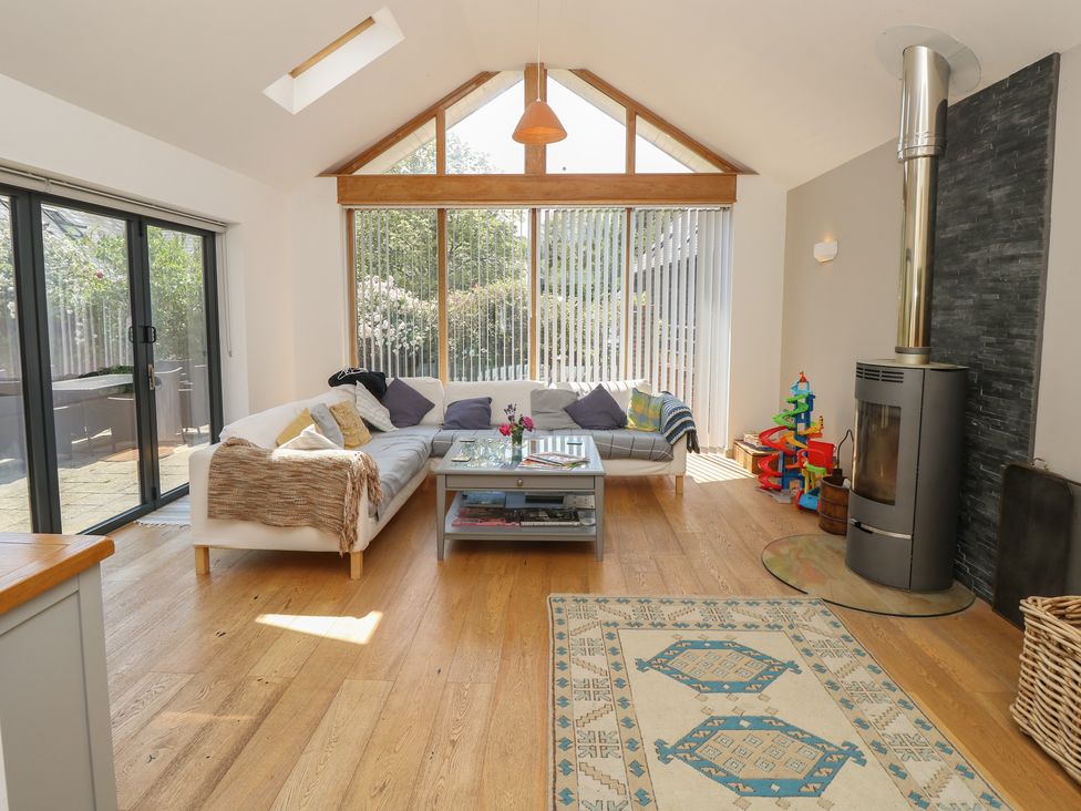 A living room with a sofa, coffee table, and a fireplace at Guildford Farmhouse in Ryde