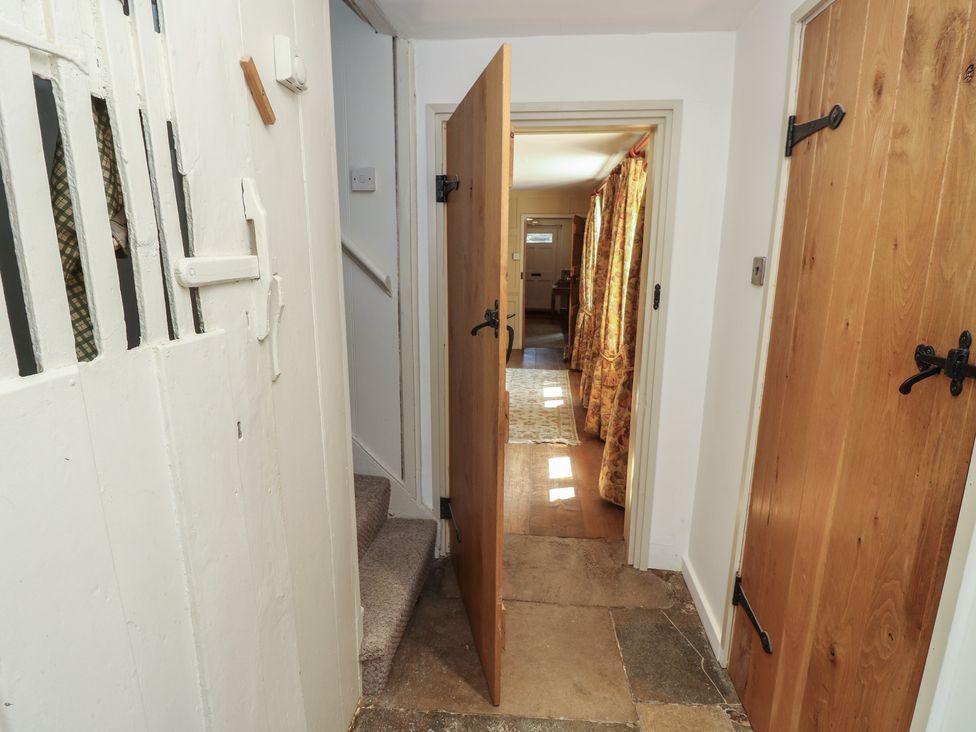 A hallway with doors and a staircase at Guildford Farmhouse in Ryde