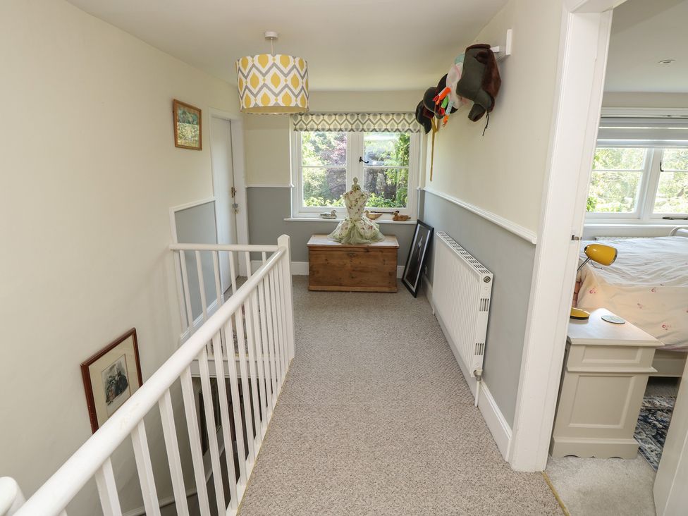 A landing with a staircase and window at Guildford Farmhouse in Ryde