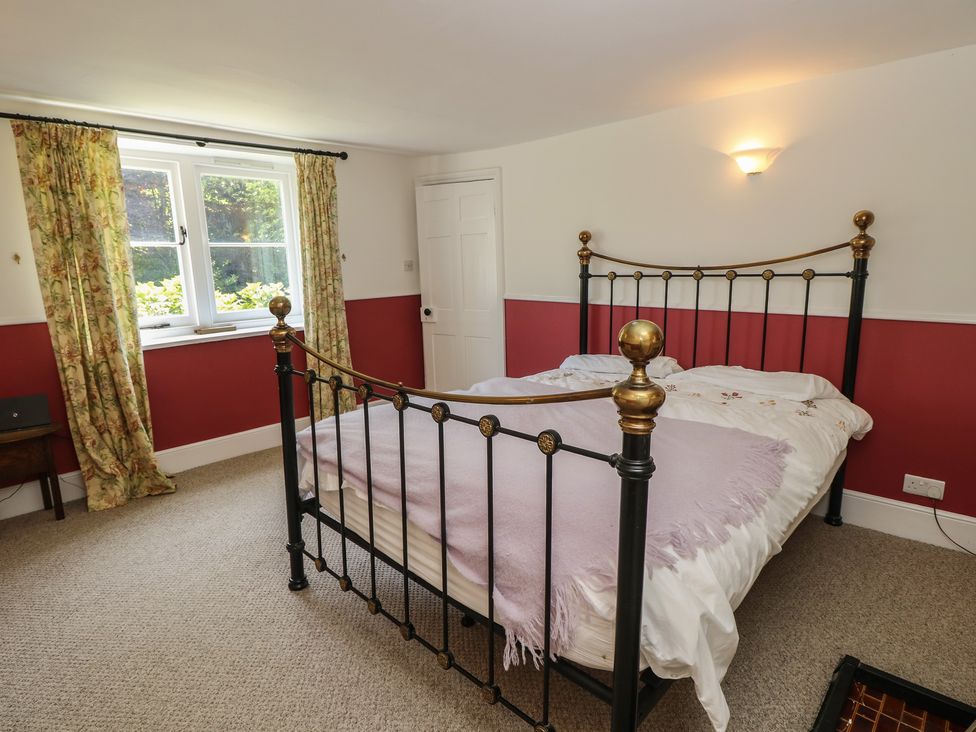 A bedroom with a bed and window at Guildford Farmhouse in Ryde