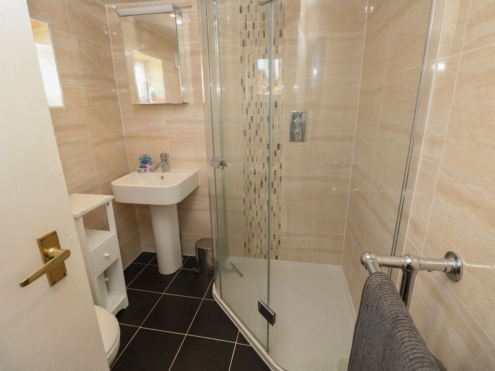 A bathroom with a shower and sink at Guildford Farmhouse in Ryde