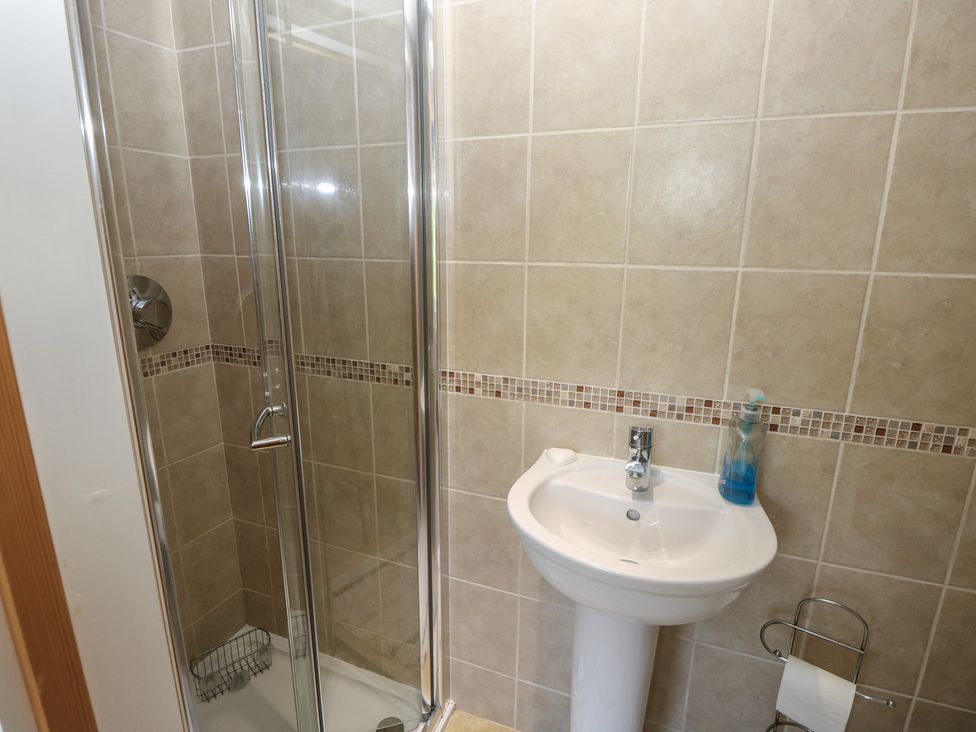 A bathroom with shower and sink at Guildford Farmhouse in Ryde