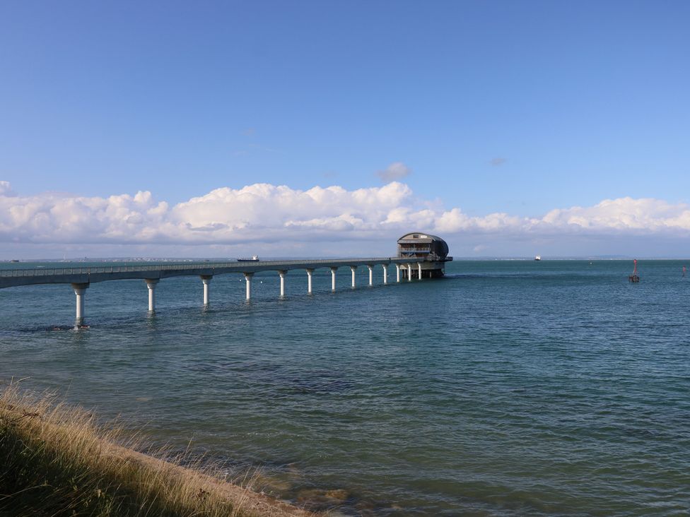A pier extending over the ocean at Guildford Farmhouse in Ryde