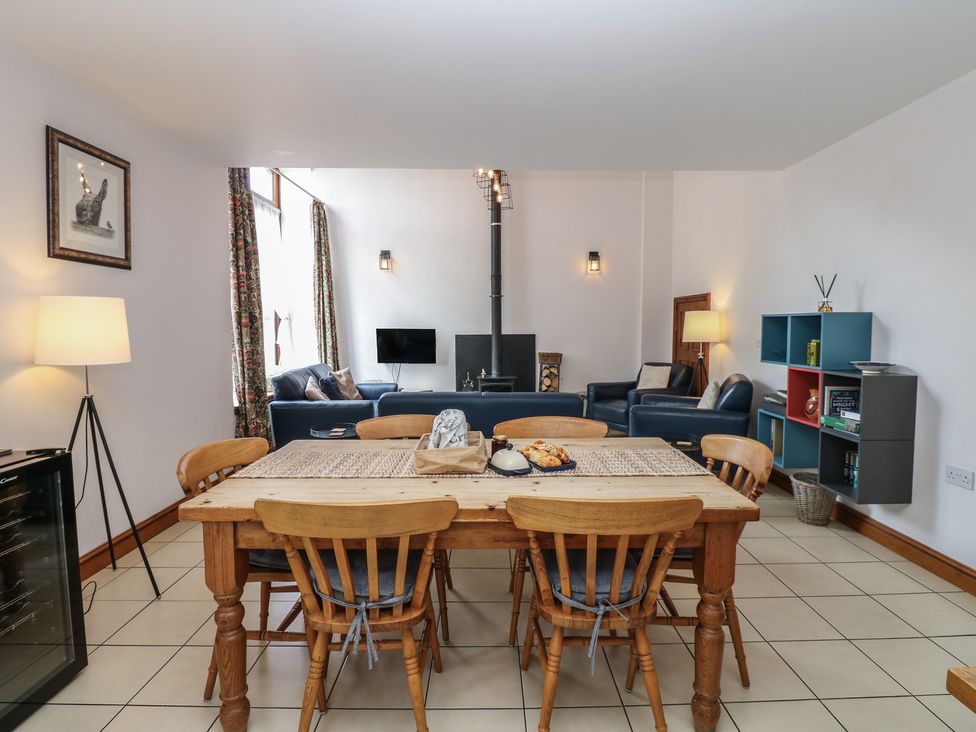 A dining room with a table and chairs at Middlefell View Cottage in Alston