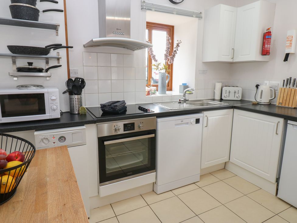 A kitchen with appliances and utensils at Middlefell View Cottage Alston