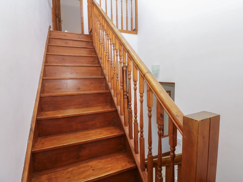 A staircase leading to a door at Middlefell View Cottage in Alston