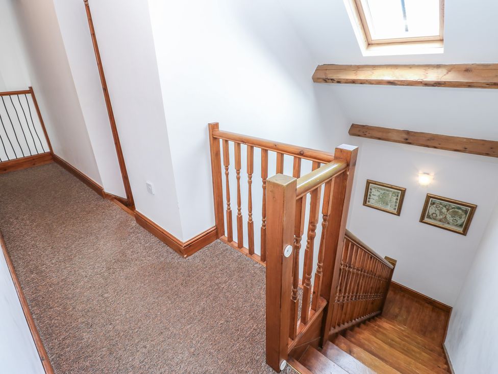 A staircase and handrail in a hallway at Middlefell View Cottage in Alston