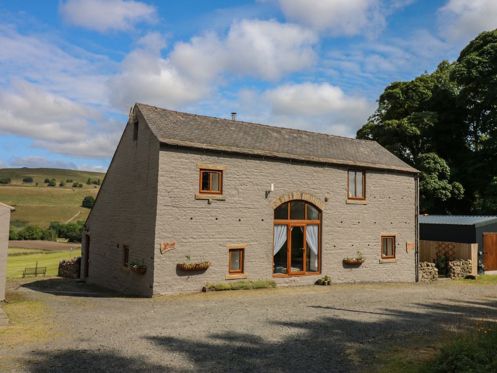 A view of a house with windows and a door at Middlefell View Cottage in Alston
