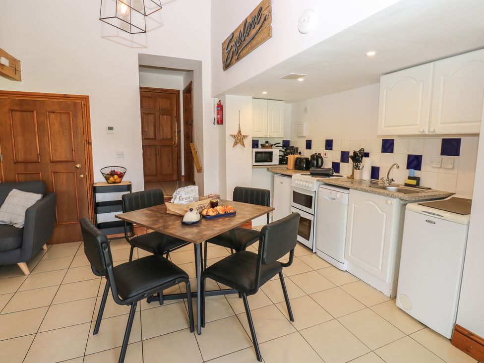 A kitchen with a dining table and chairs at Wellhope View Cottage Alston