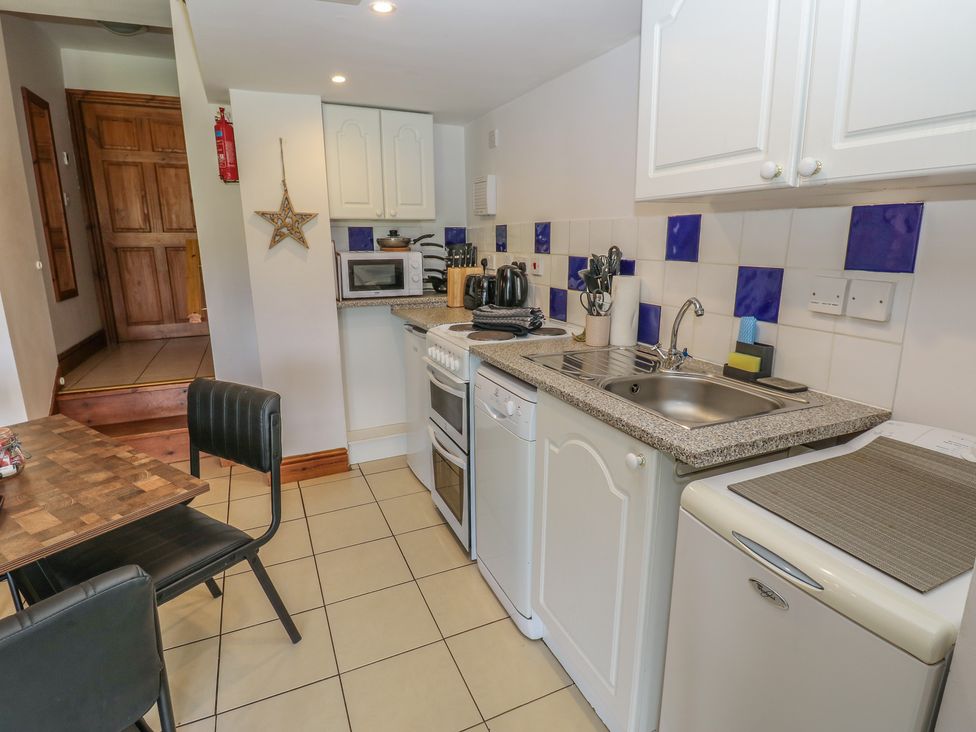 A kitchen with a table and chairs at Wellhope View Cottage in Alston