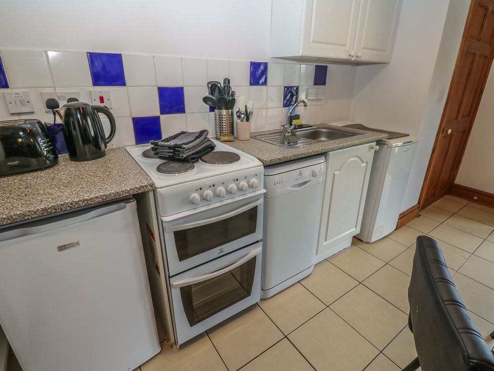 A kitchen with appliances and utensils at Wellhope View Cottage Alston