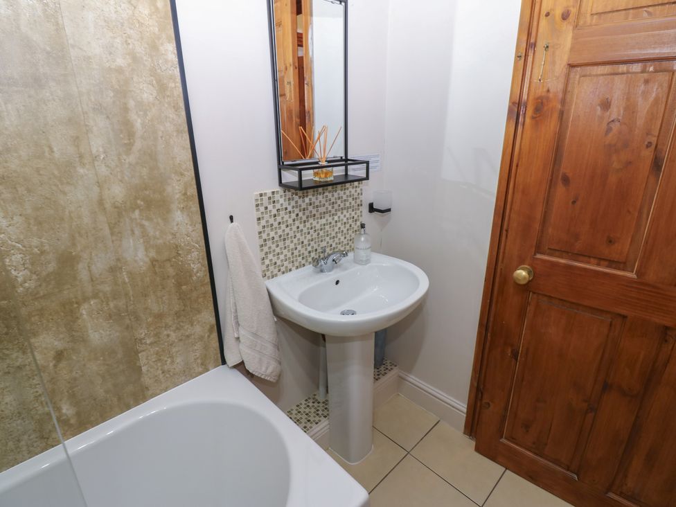 A bathroom featuring a sink and bathtub at Wellhope View Cottage Alston