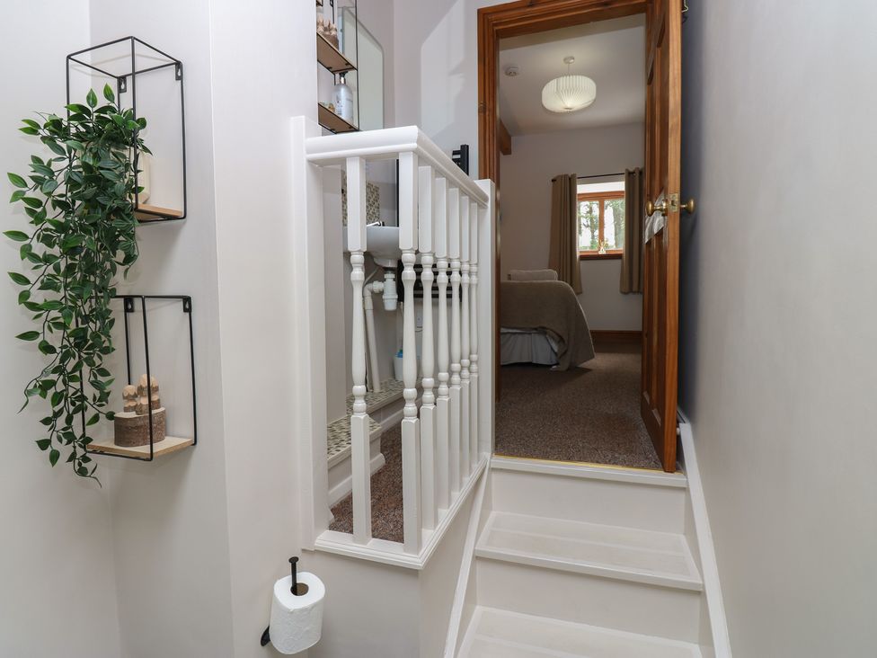 A hallway with stairs leading to a room at Wellhope View Cottage in Alston