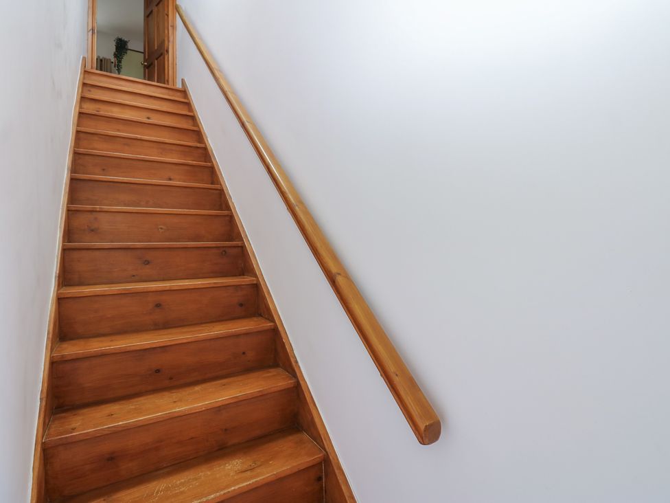 Stairs leading up to a door at Wellhope View Cottage Alston