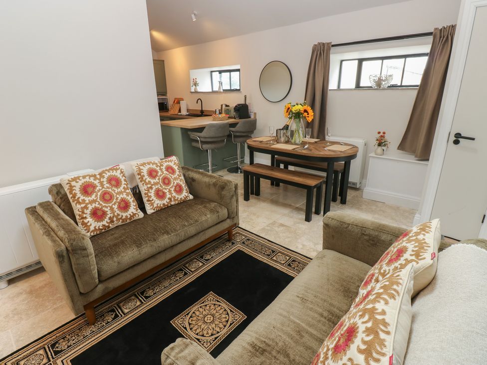 A living room with a sofa and dining area at Antoninus Barn 2 in Ebchester