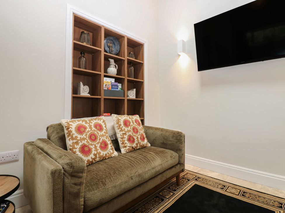 A living room with a sofa and shelves at Antoninus Barn 2, Ebchester