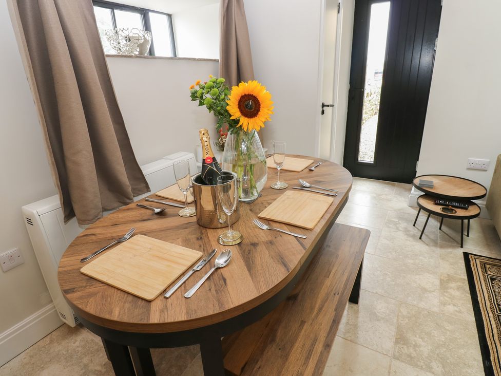 A dining room with a round table set for a meal at Antoninus Barn 2 in Ebchester