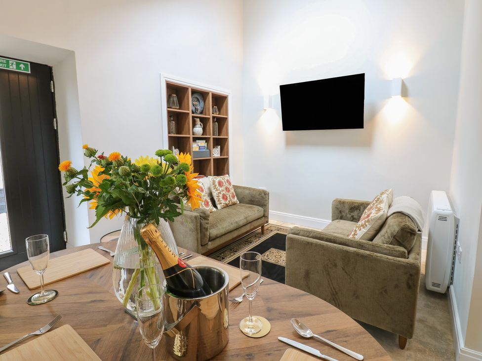 A living room with a dining table and sofa at Antoninus Barn 2 in Ebchester
