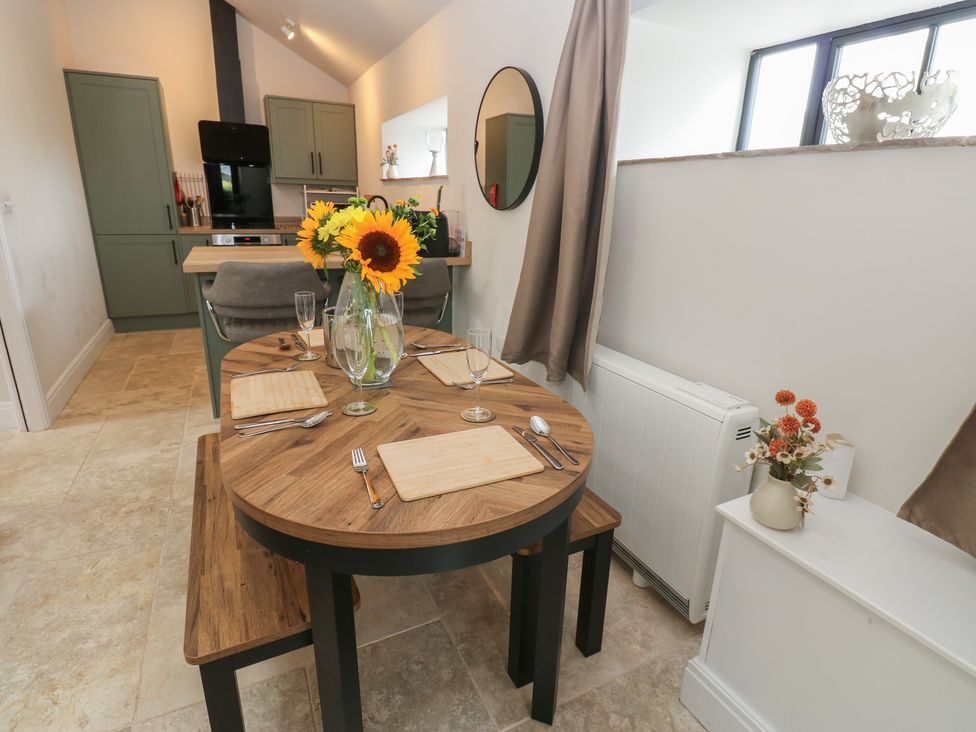 A dining room with a round table set for meals at Antoninus Barn 2 Ebchester