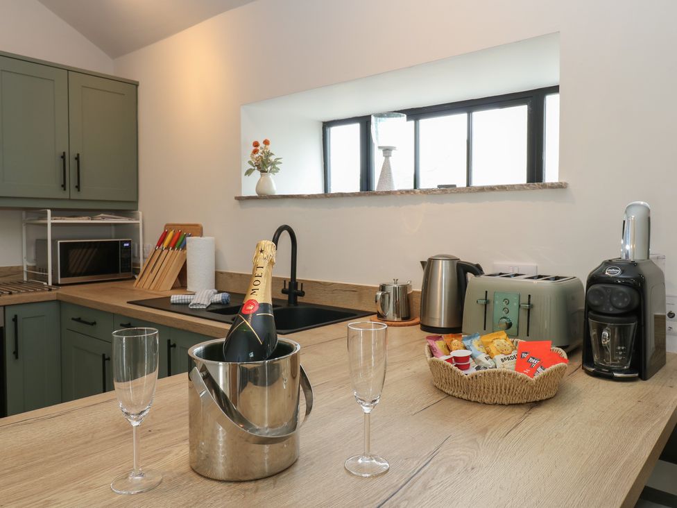 A kitchen with a sink, microwave, and coffee machine at Antoninus Barn 2, Ebchester