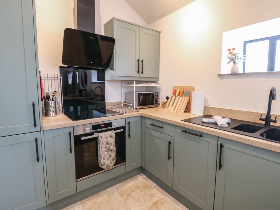 A kitchen with cabinets and appliances at Antoninus Barn 2 in Ebchester