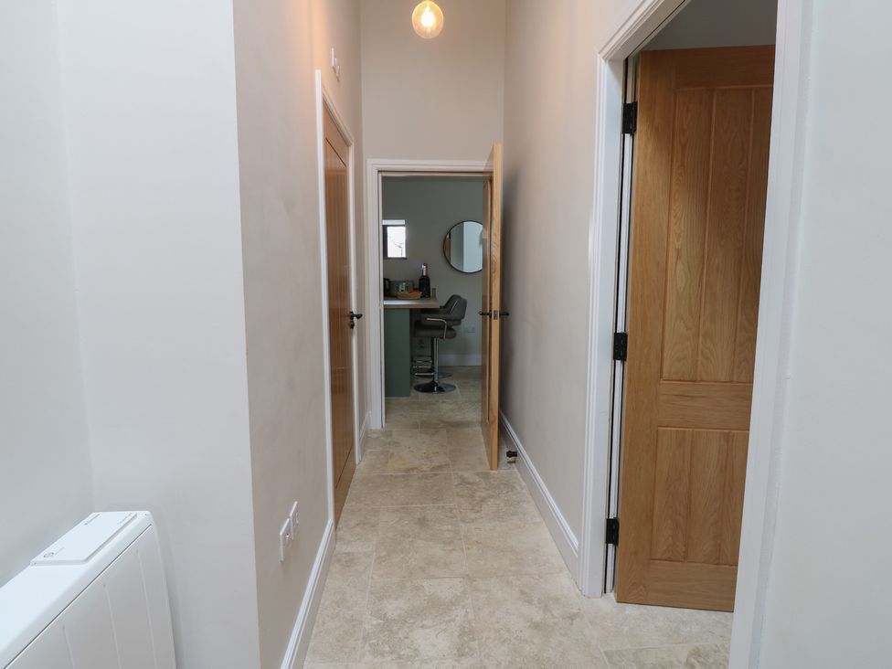 A hallway with doors and a counter at Antoninus Barn 2 Ebchester